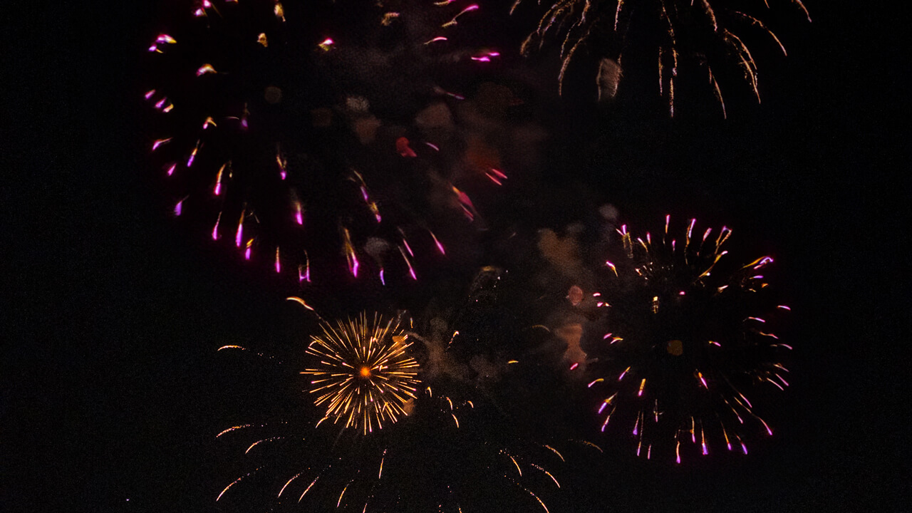 Gold and pink fireworks explode in the Hamden night sky