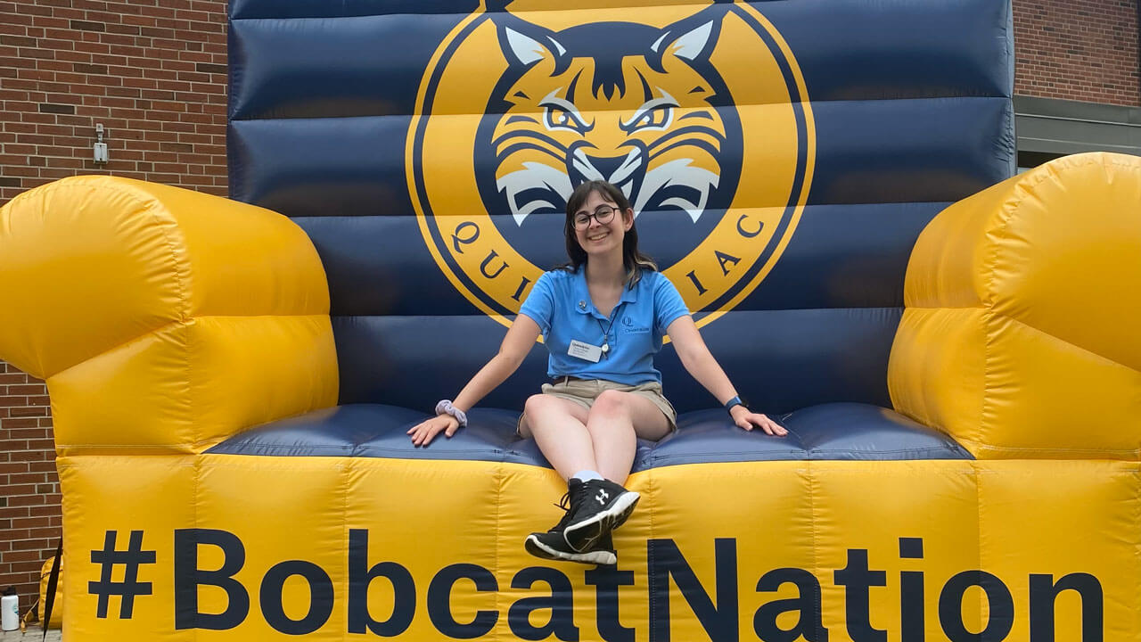 Student sitting on trampoline with #bobcat nation written on the front