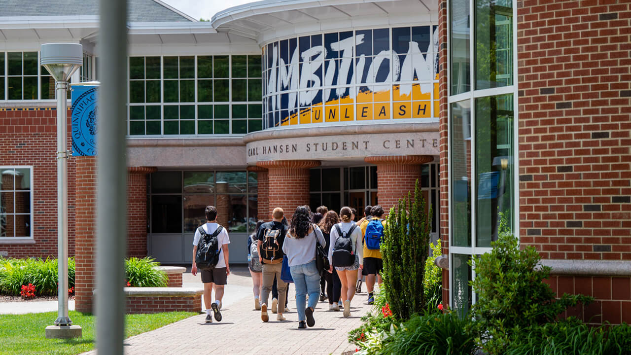 A group of new students walk into the Carl Hansen Student Center during Orientation