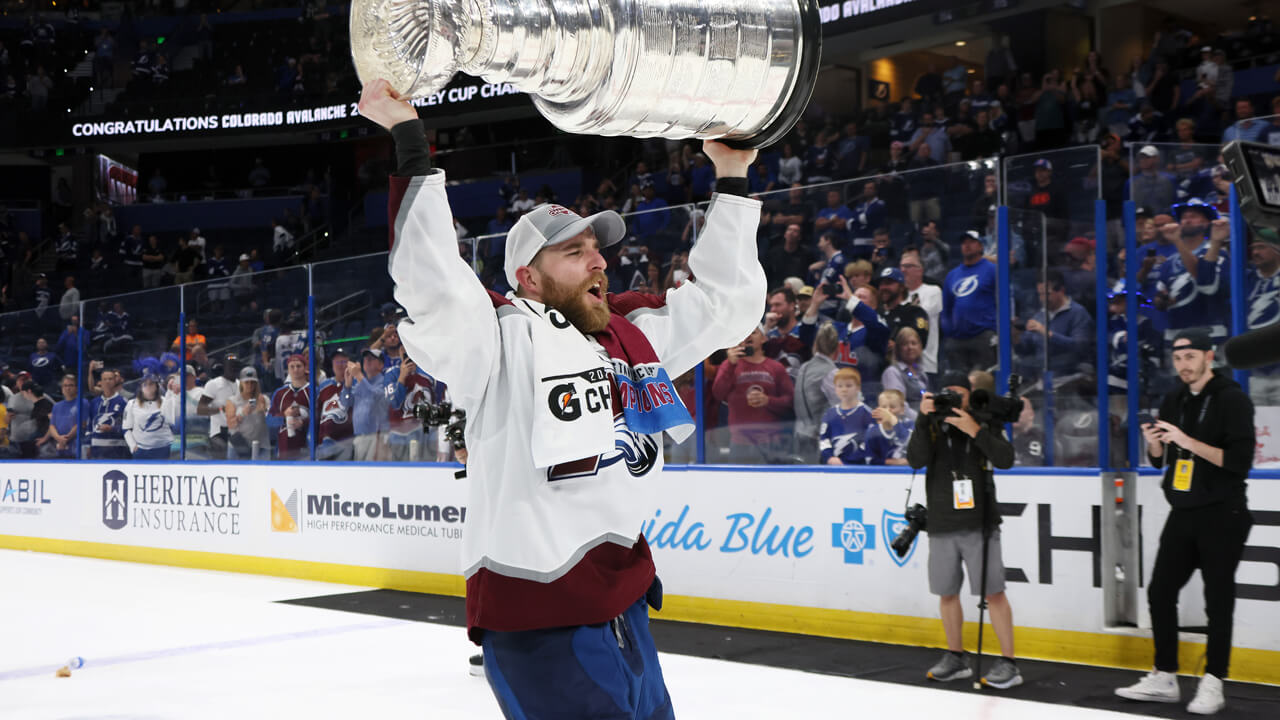 Quinnipiac alum Devon Toews cheers with the Stanley Cup after winning with the Colorado Avalanche
