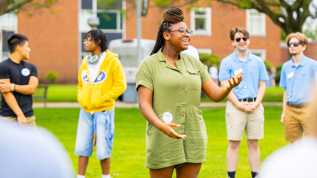 Individuals talking and standing on the Quad during Orientation