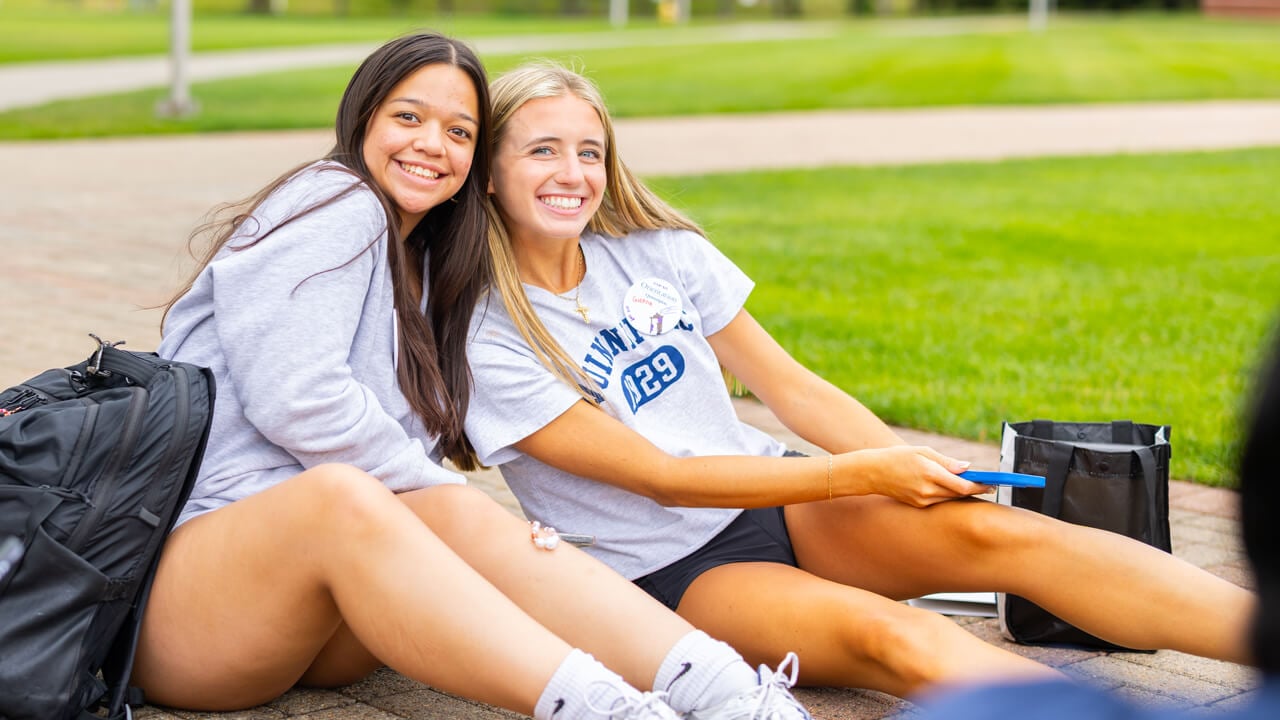 Individuals pose for a photo on the Quad during Orientation
