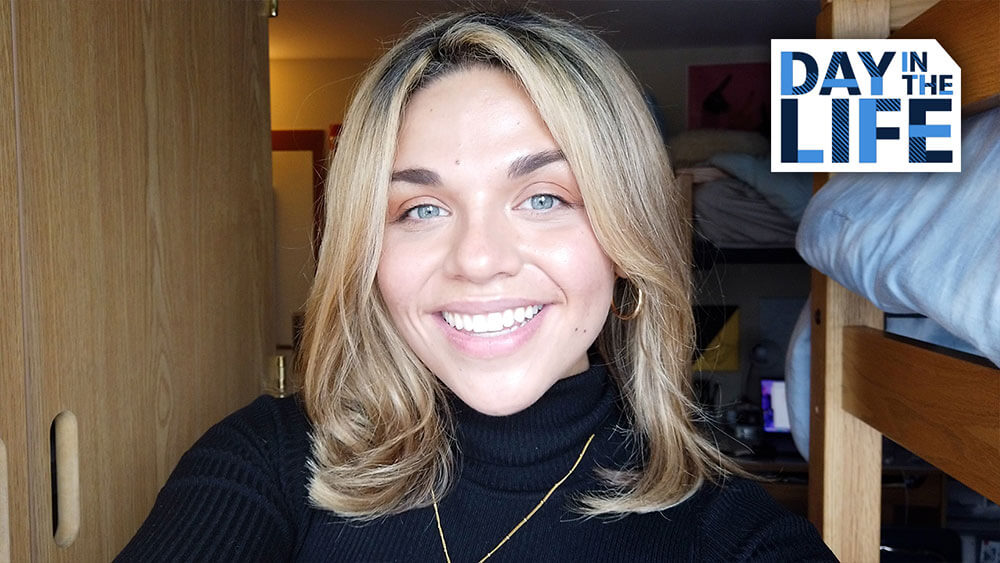 Journalism student Nicole McIsaac standing in her dorm, starts video