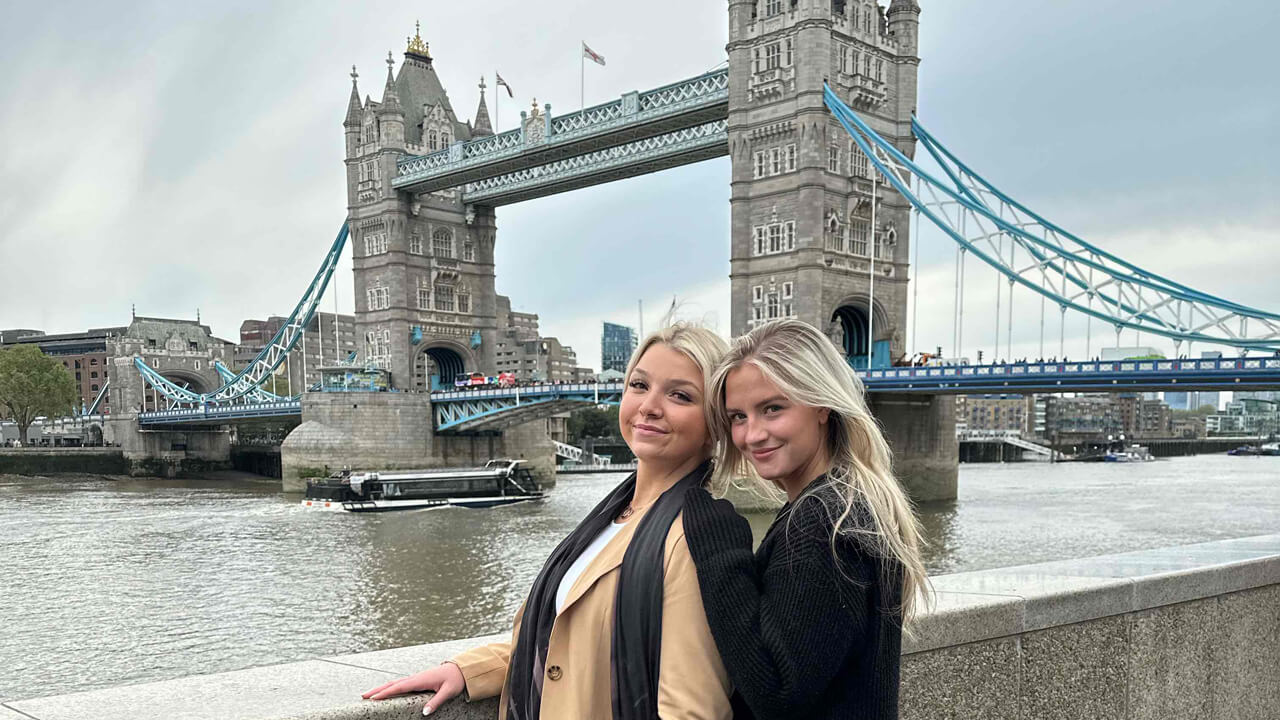 2 female student posing in front of the London Bridge