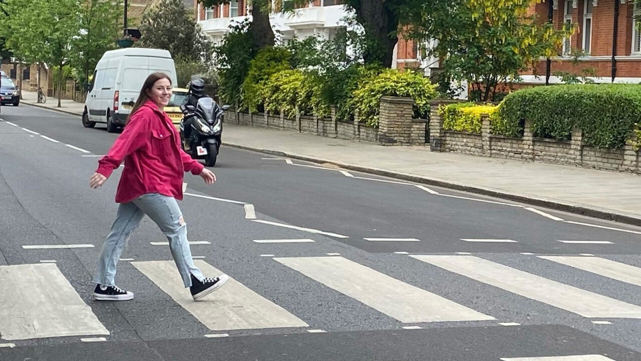 A female student crossing Abbey Road