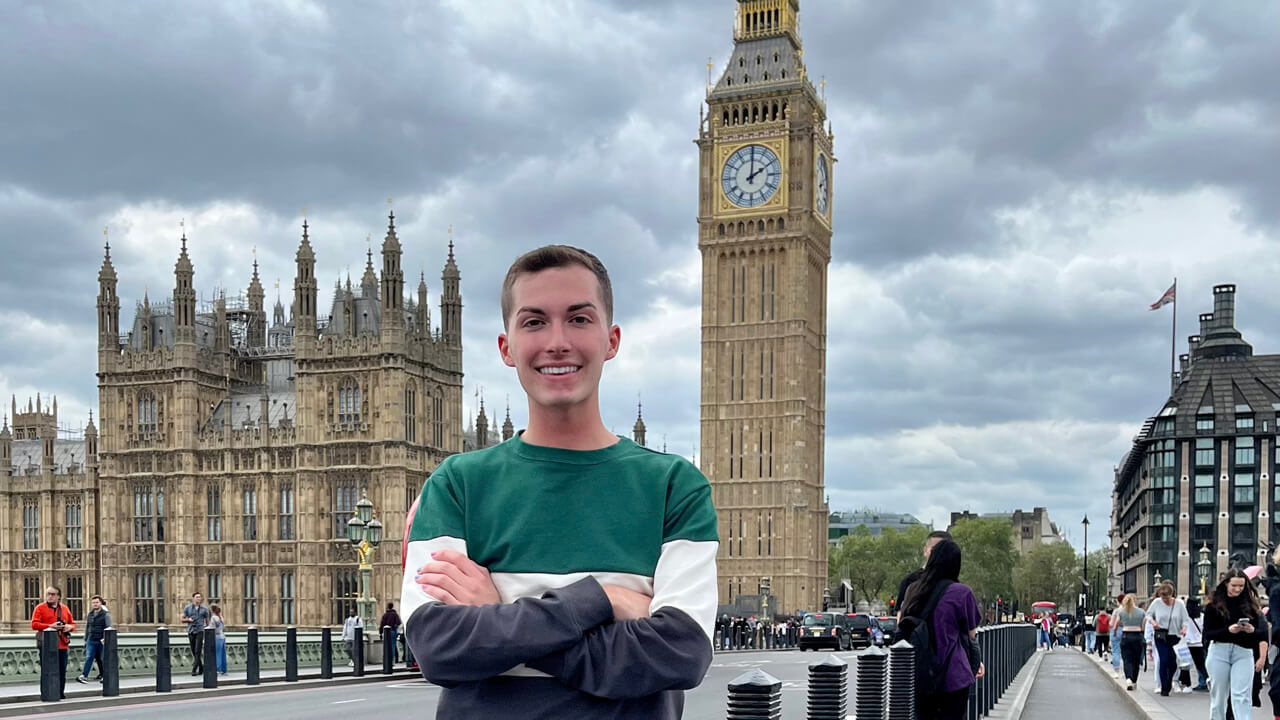 A male student posing in front of Big Ben
