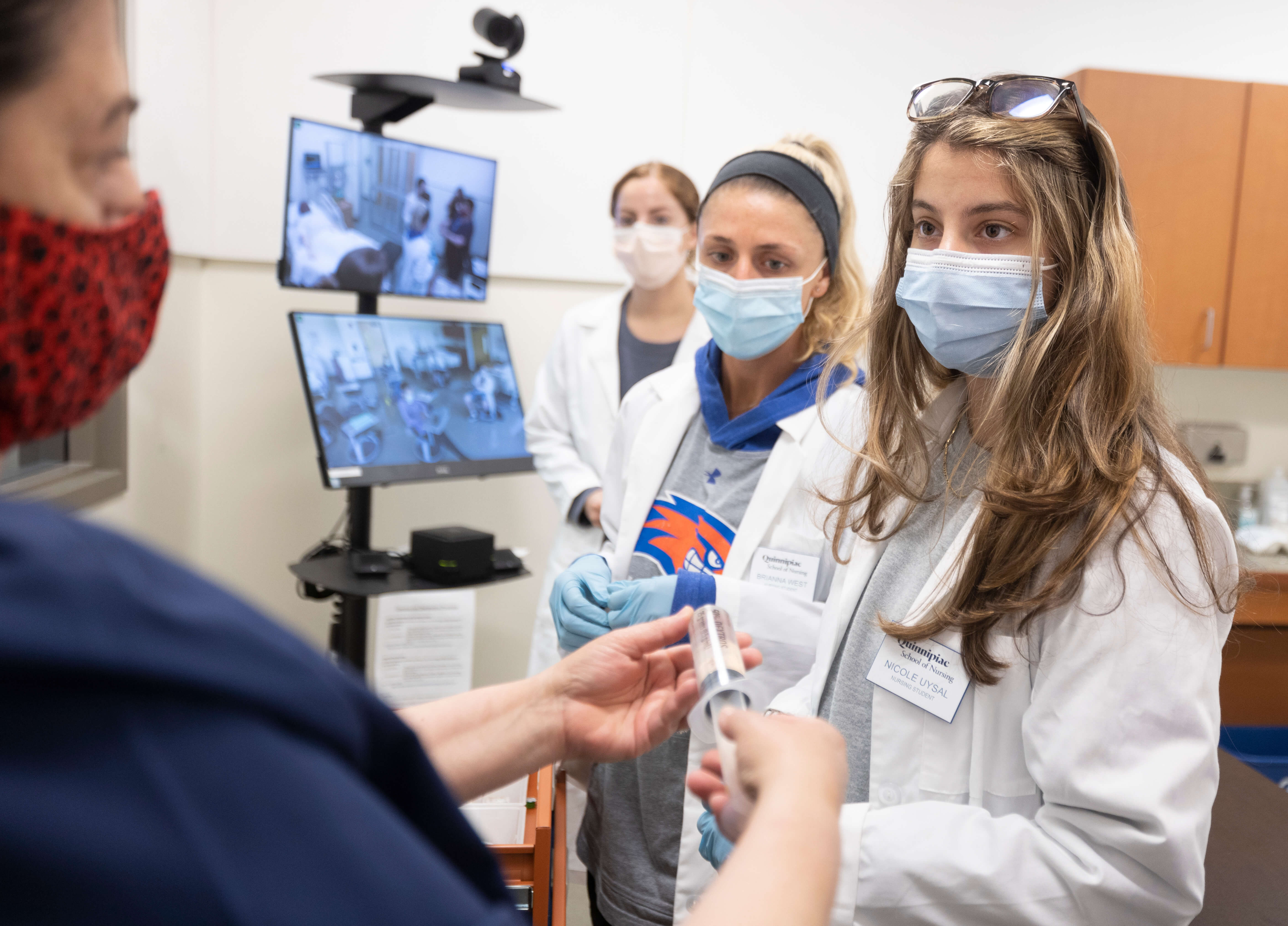 Students in Quinnipiac University’s accelerated nursing program conduct a mock patient assessment Wednesday, June 30, 2021
