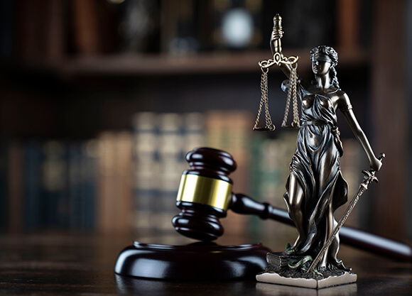 Stock image of a gavel on a courtroom table