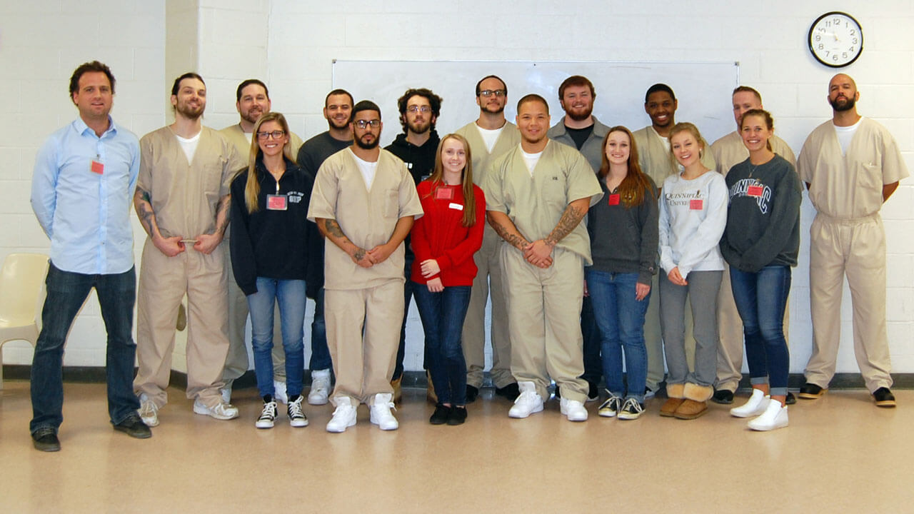 Participants of the Prison Project program smile for a group photo