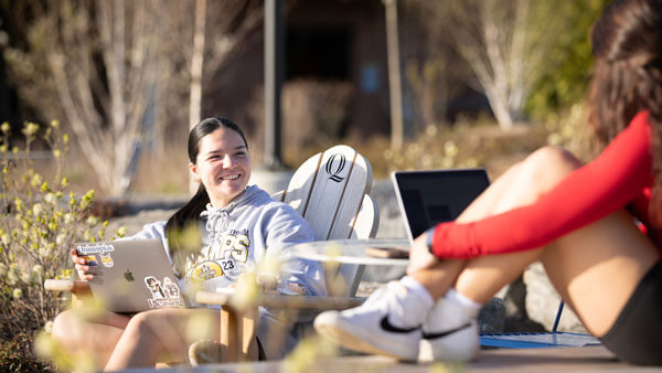 Students sitting outside the Recreation and Wellness Center