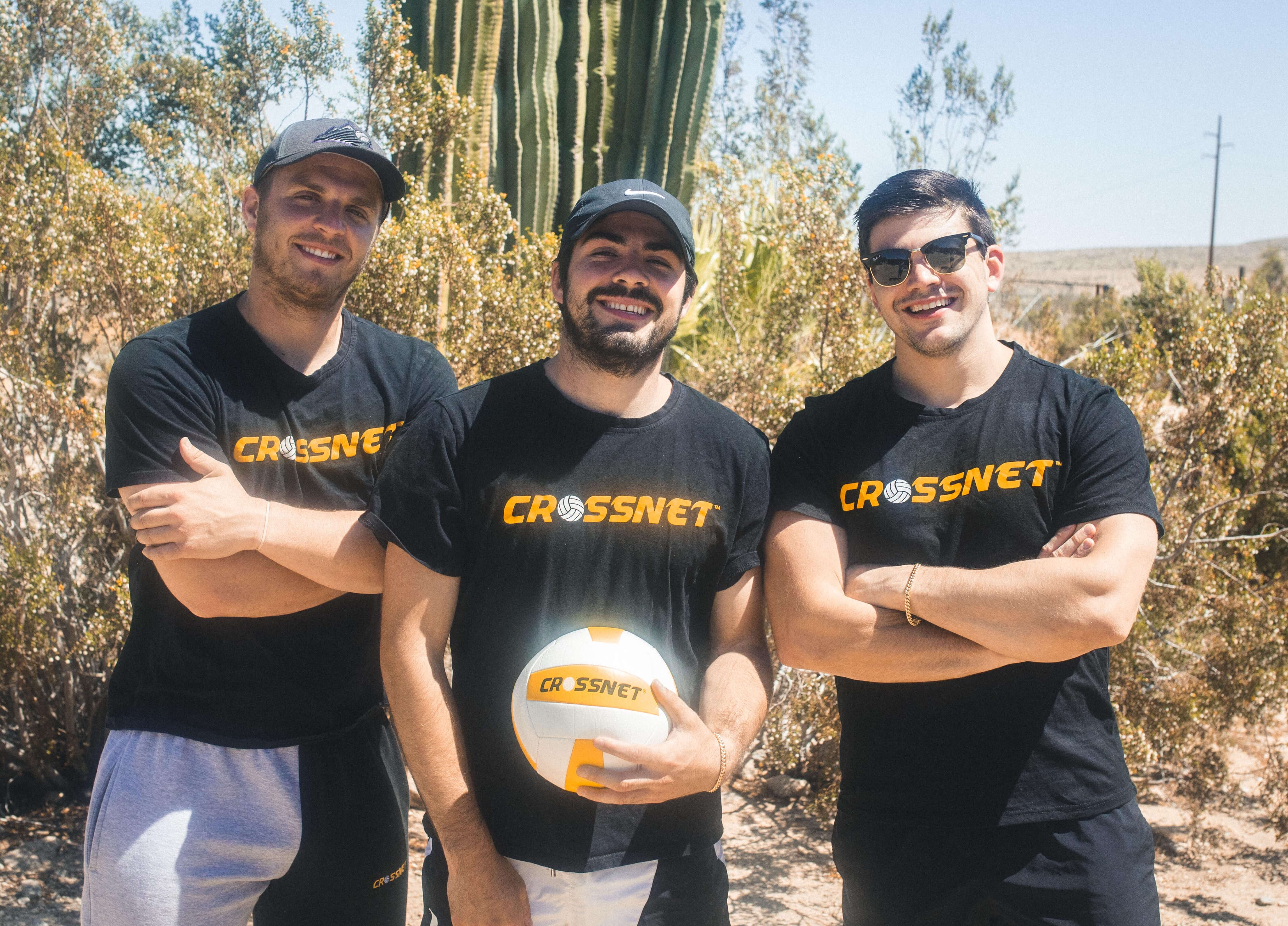 The three founders of CROSSNET standing together with a volleyball