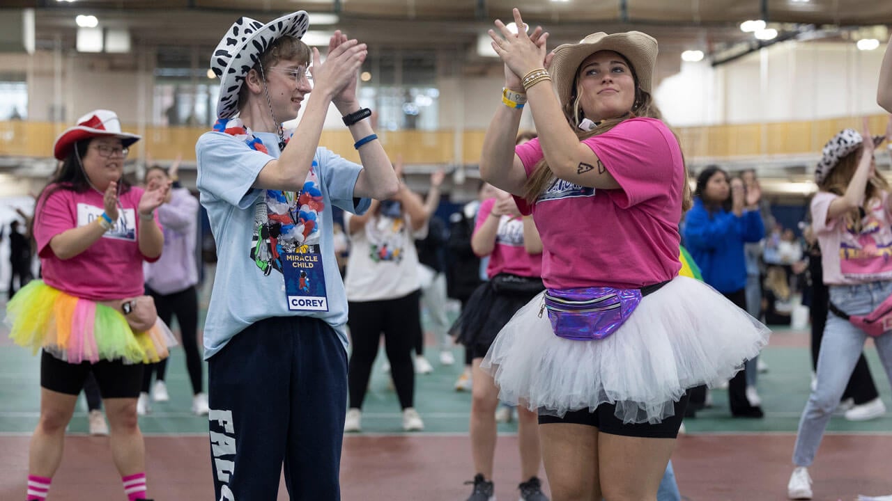 Quinnipiac girl and child dancing for charity
