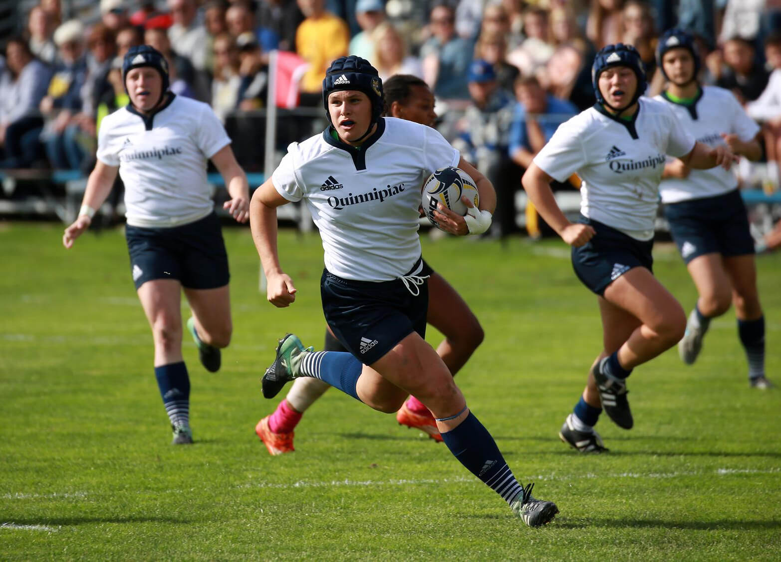 Ilona Maher on the rugby field in a game with her teammates