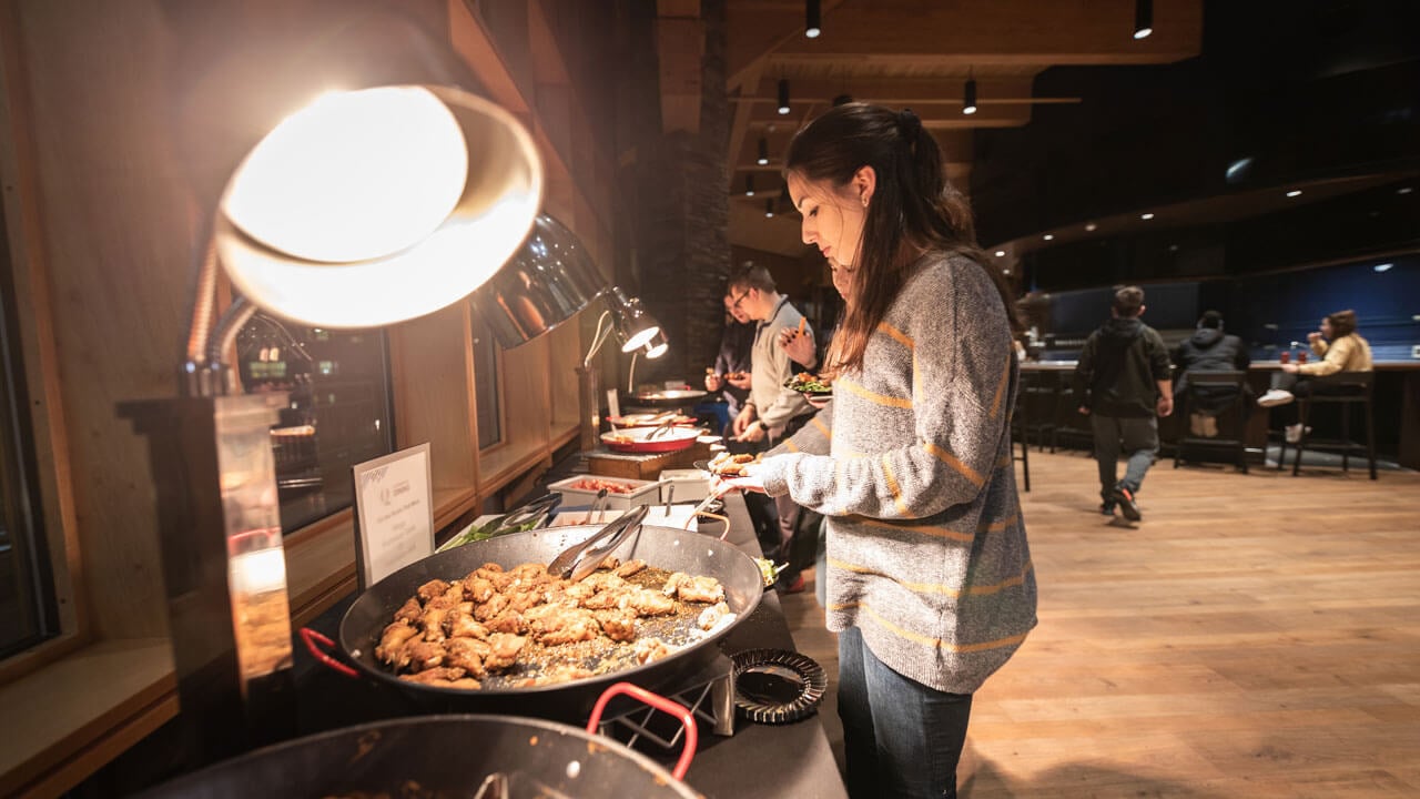 Students get food during an event in the pub