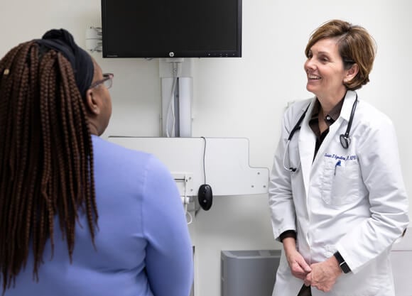 Clinical Assistant Professor of Nursing and Nurse Practitioner Program Director Susan D’Agostino, DNP, performs a routine check-up on a patient.