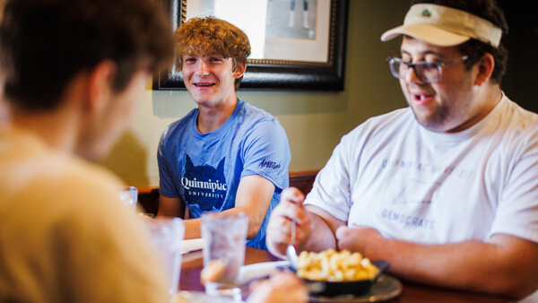 A Quinnipiac student and his family eat a meal at Eli's restaurant