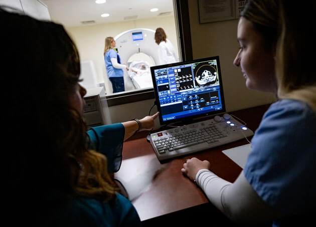 Radiologic science students analyze scans during an imaging session.