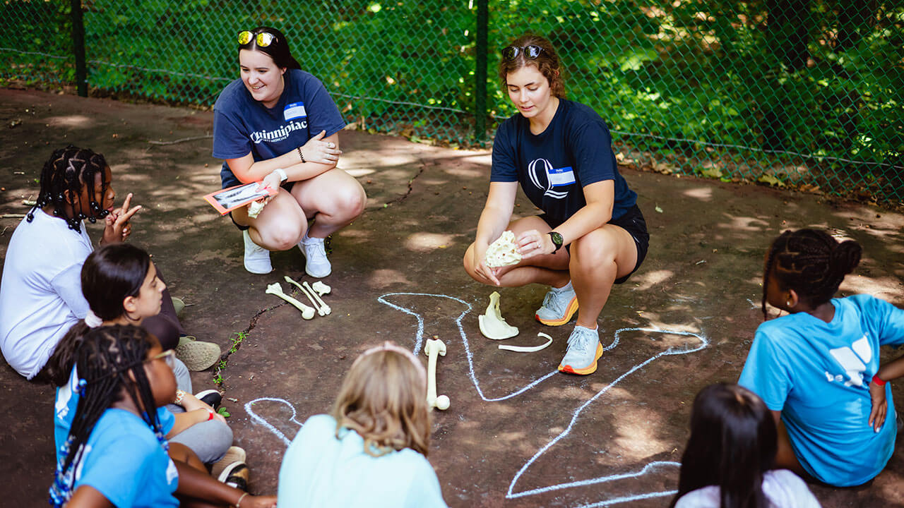 Students teach campers about the locations of skeletal bones