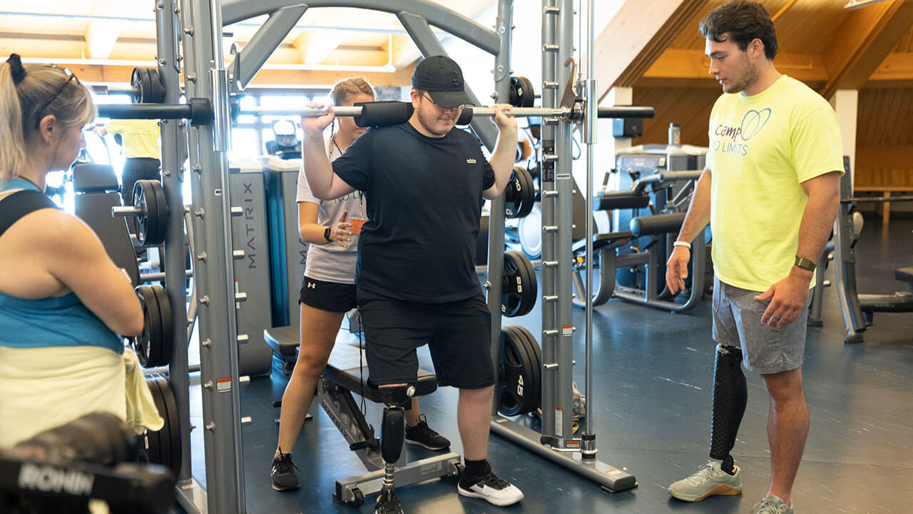 A camper lifts weights in the York Hill fitness center
