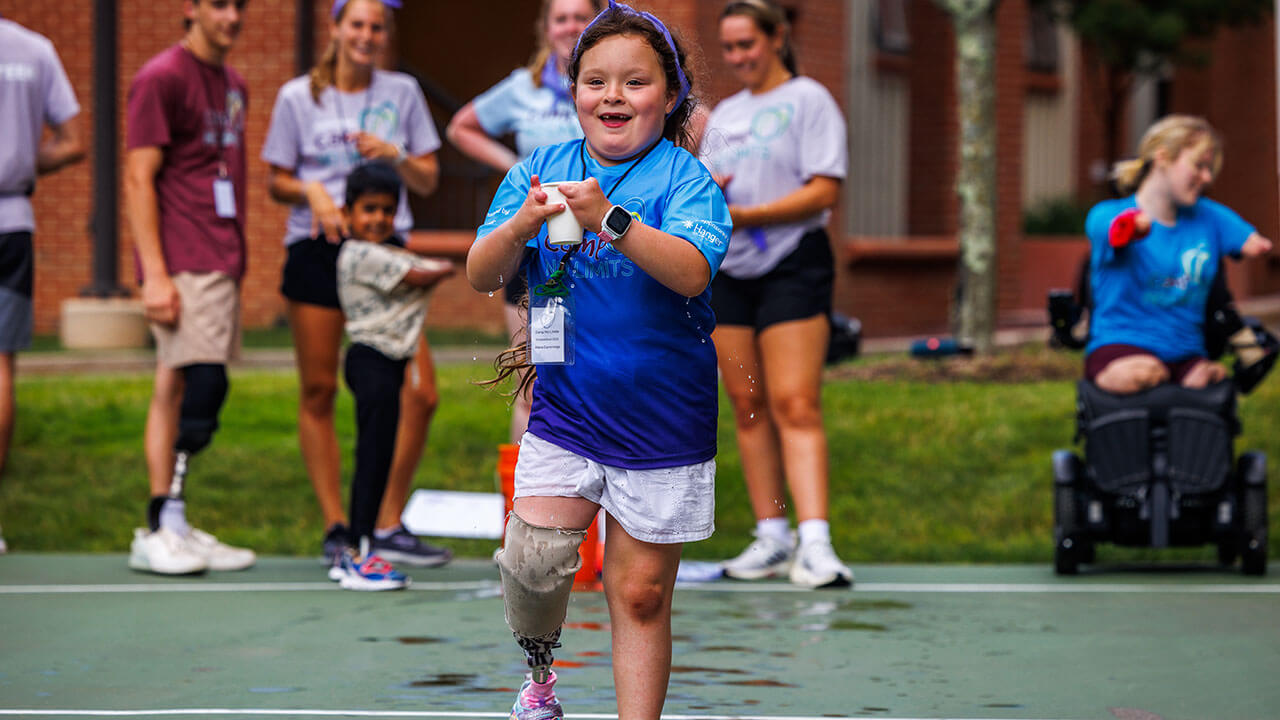 A young camper runs during a relay race