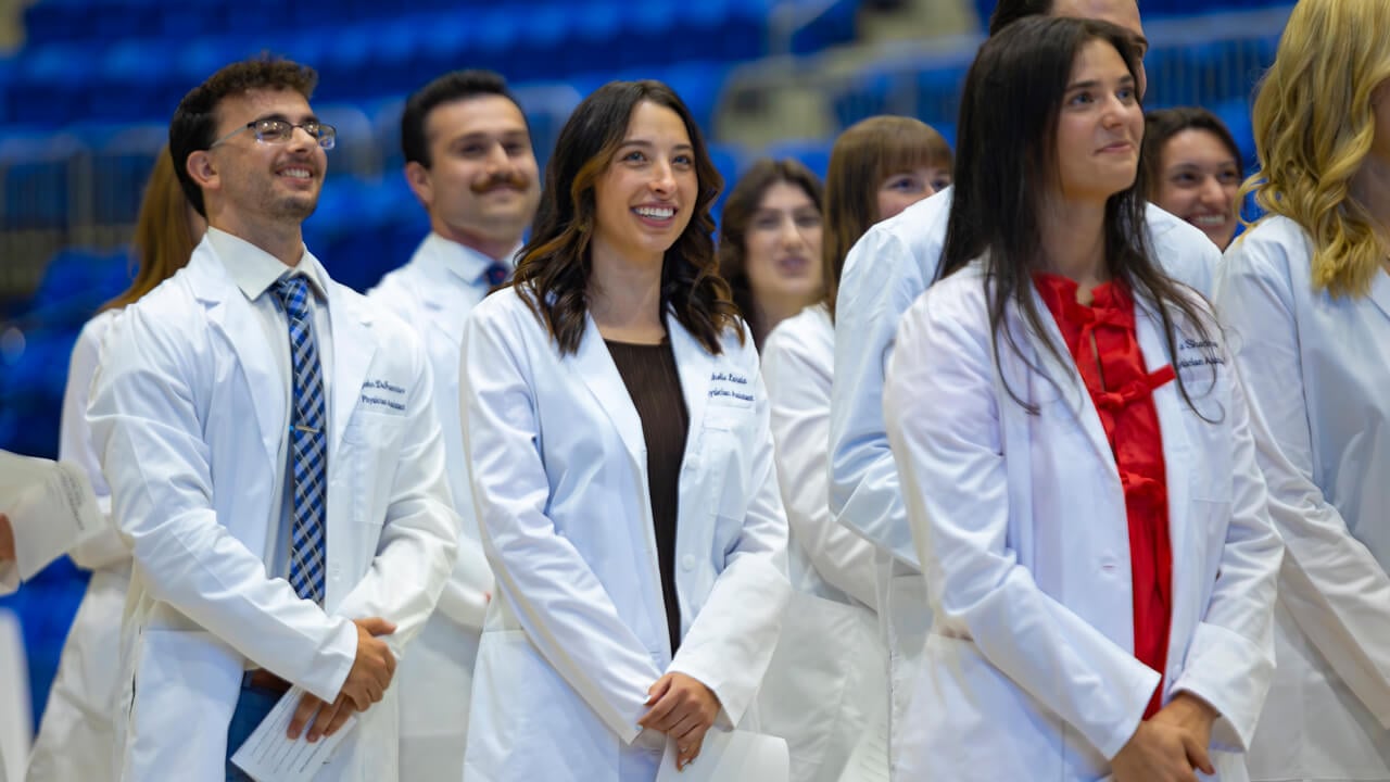 Students standing and smiling