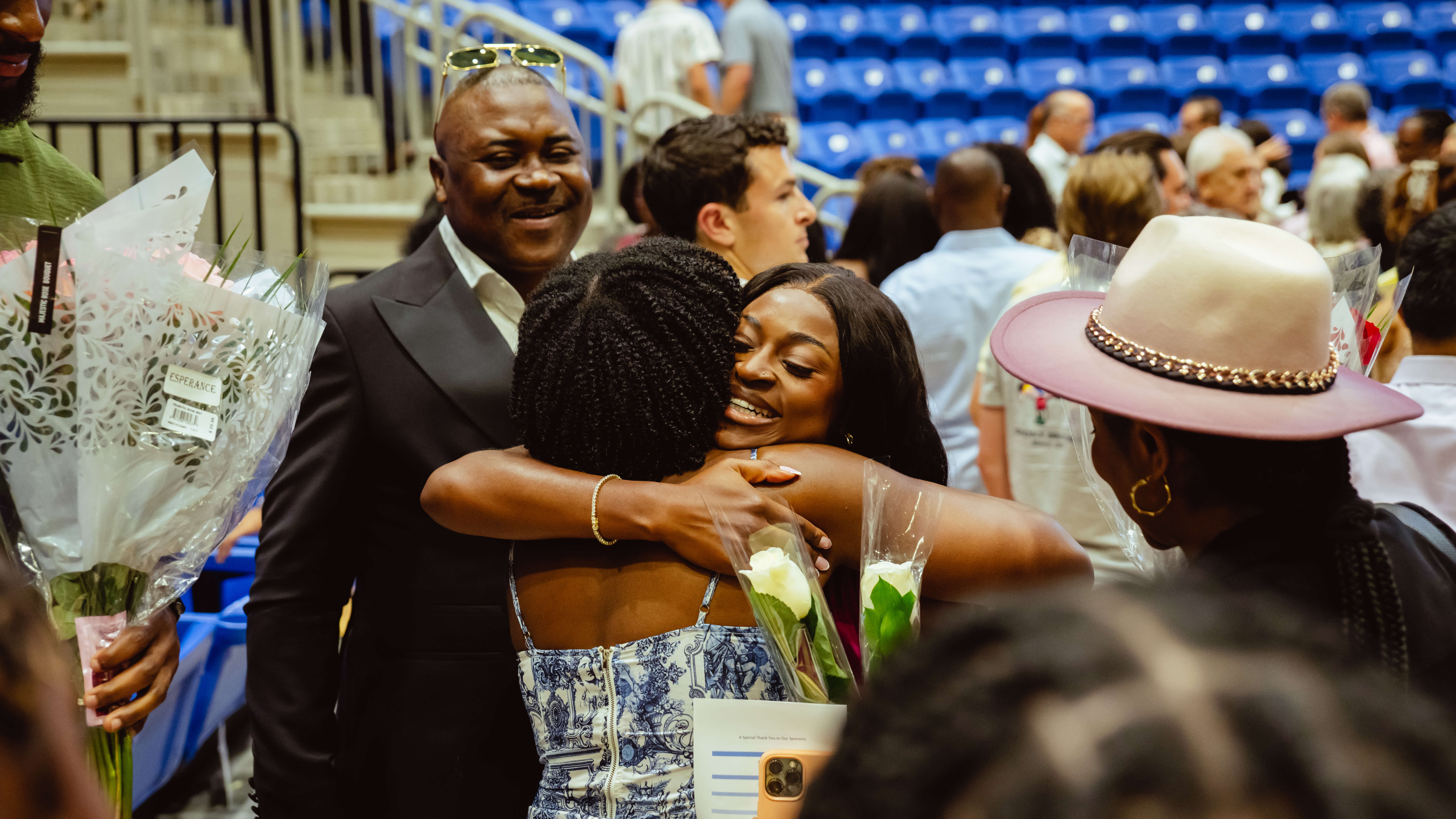 A graduate hugs her family after the ceremony