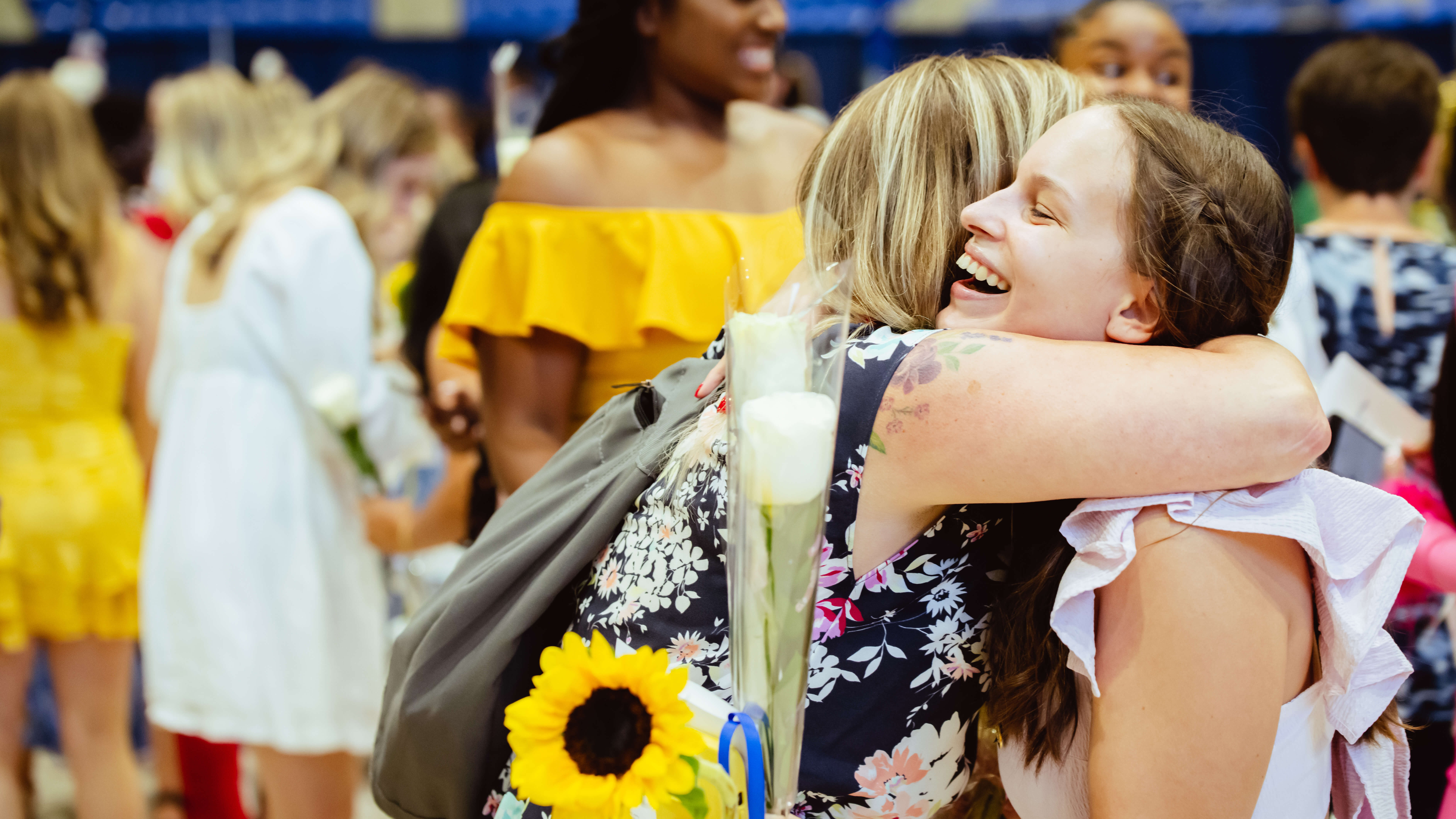 Graduates hug their family and friends after the Pinning Ceremony