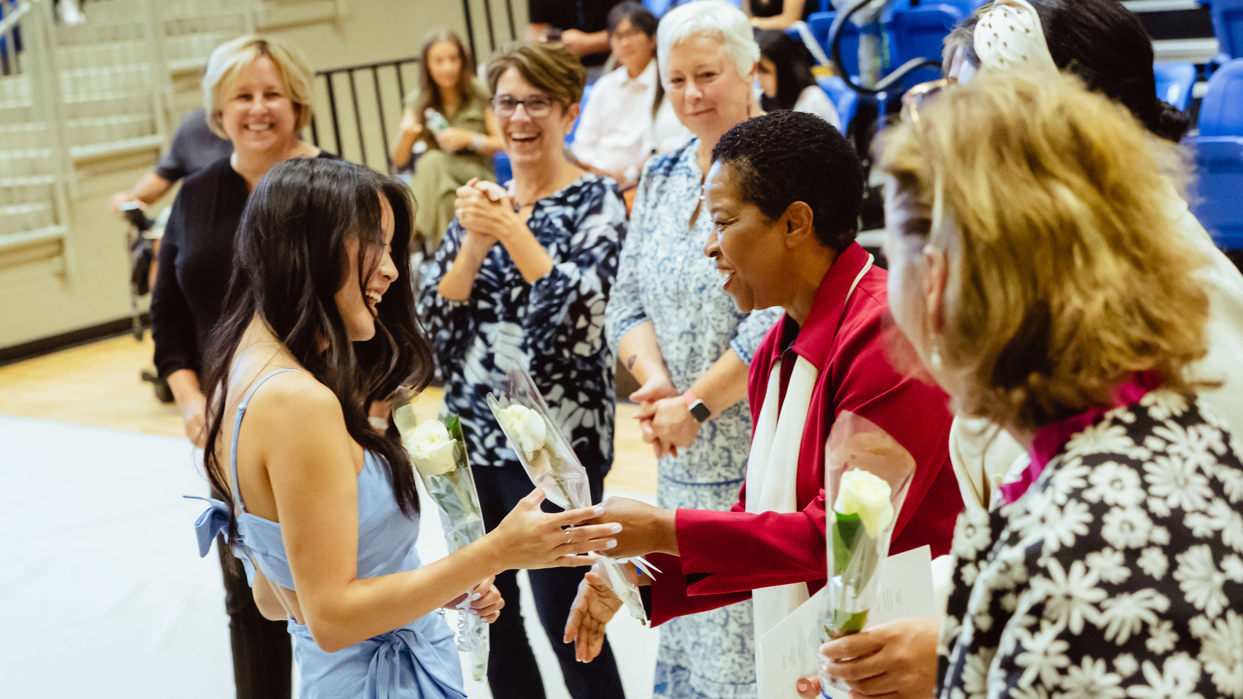 Graduates receive their roses during the ceremony