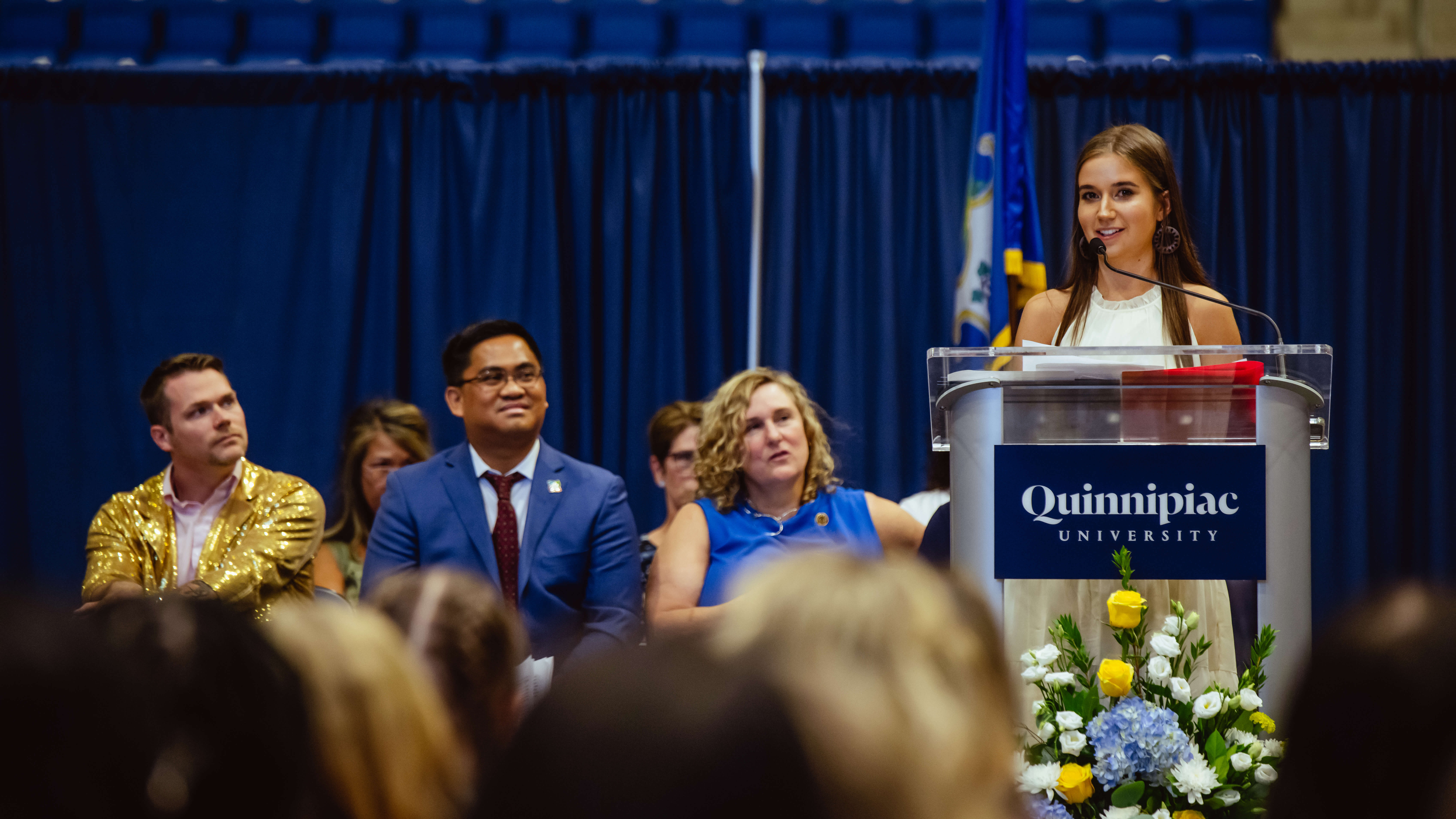 A graduate speaks on stage during the ceremony