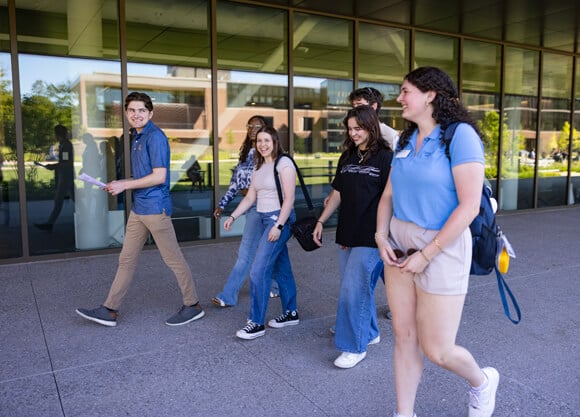 Student leaders walk and talk with new students during Welcome Weekend
