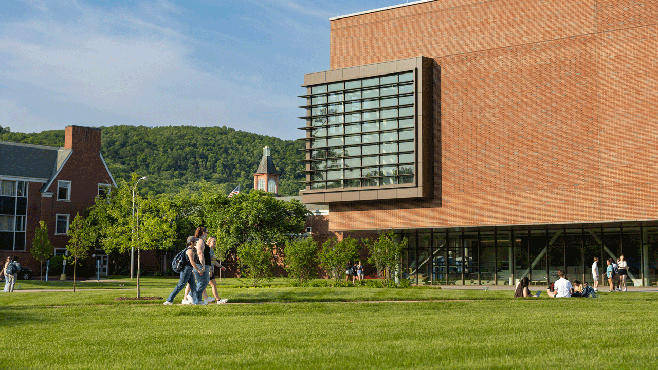 Students walk across the South Quad in front of The SITE