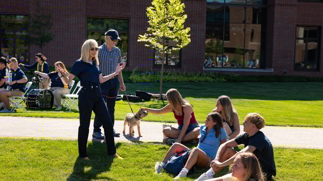 President Marie Hardin smiles and talks to students on South Quad
