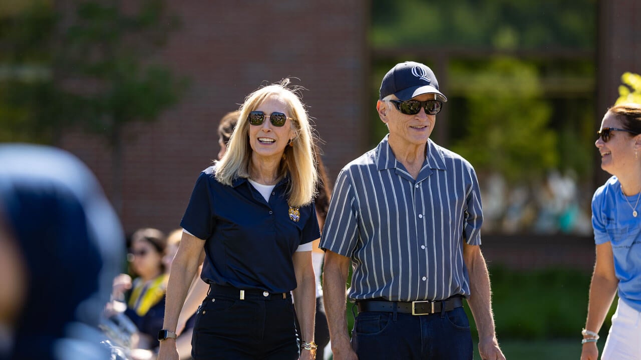President Marie Hardin and her husband Jerry Kammer walk across south quad