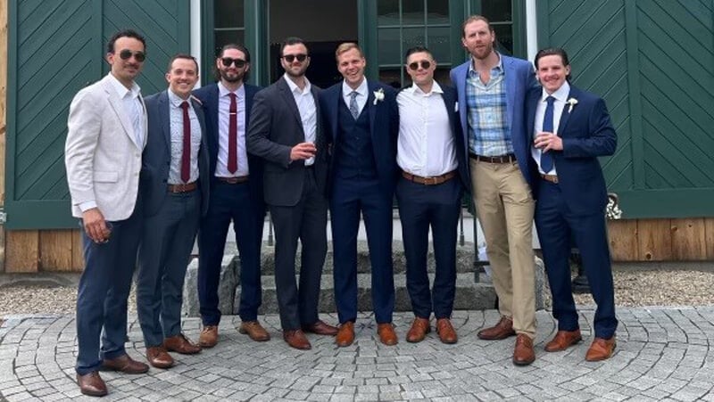 Michael Garteig poses for a photo with several other people on his wedding day