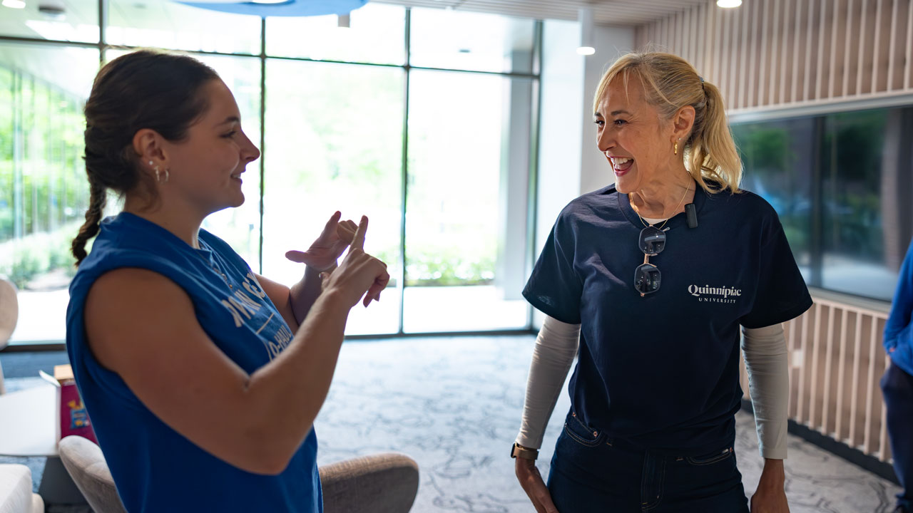 President Marie Hardin talking to a student in The Grove