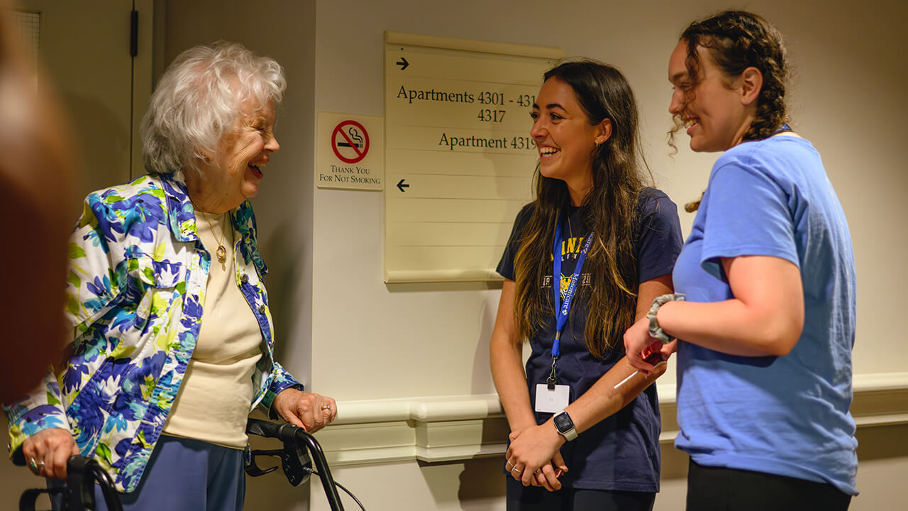 Students talk with a resident at Masonicare.