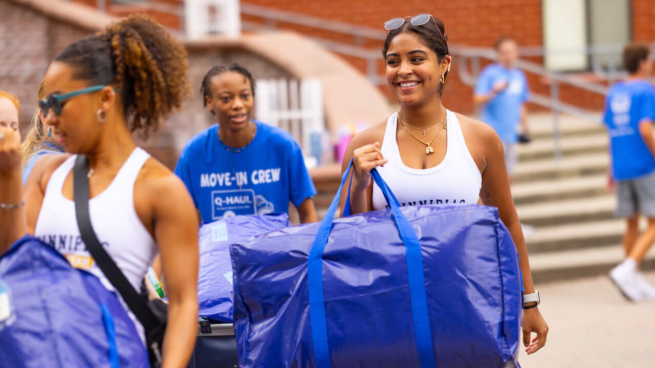 Students help new Bobcats carry their dorm supplies.