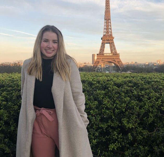 Brynn Martin in front of the Eiffel Tower