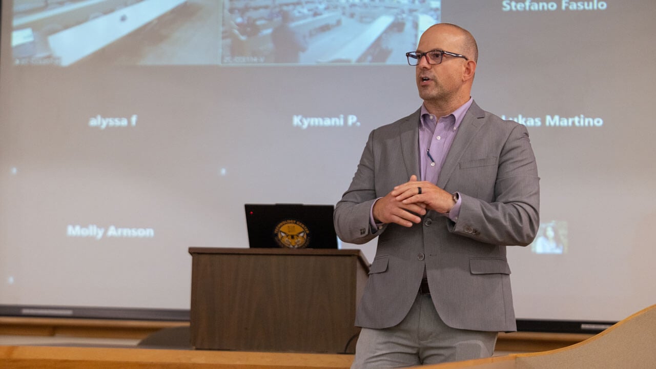 Faculty member speaks to graduate students.