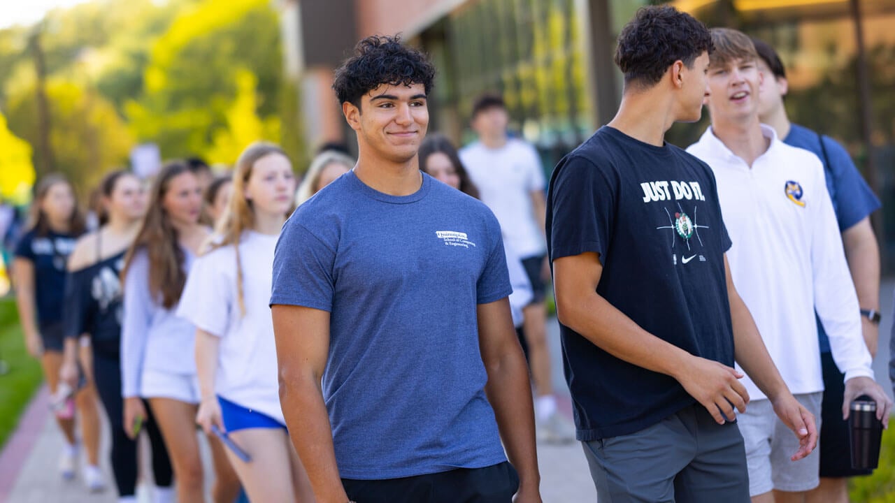 Student smirks as he looks out to South Quad
