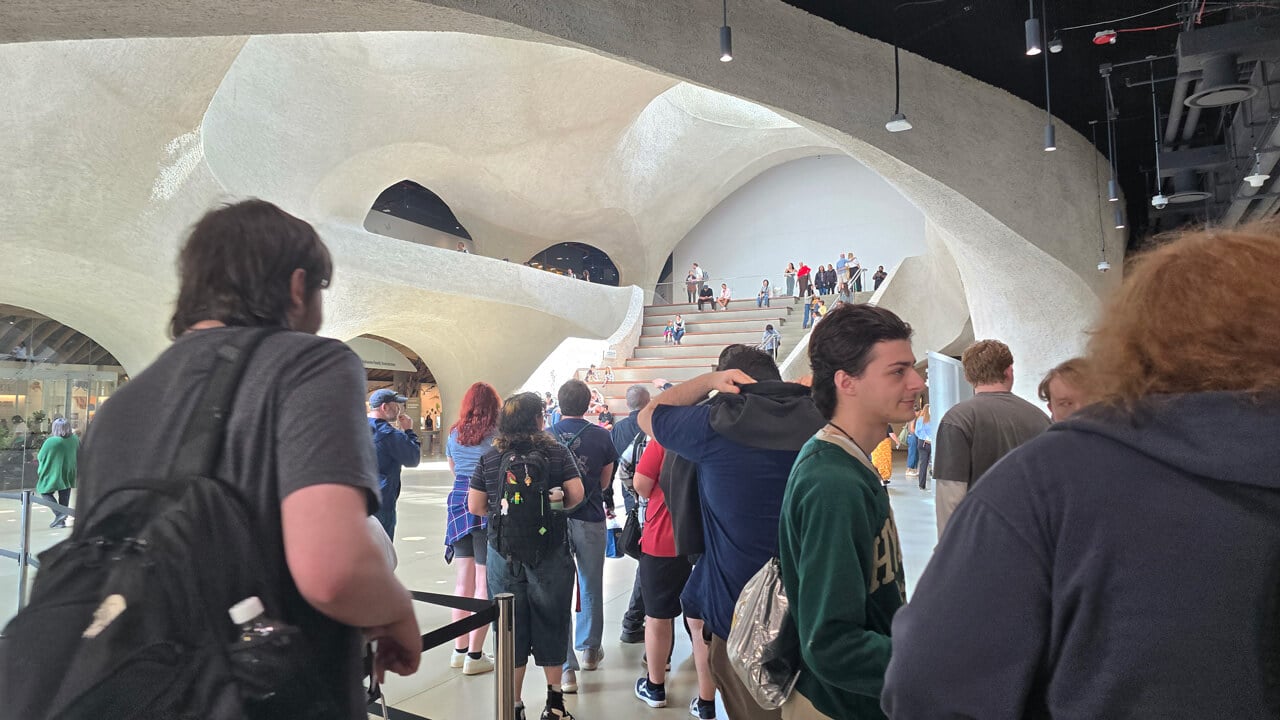 A photo of students walking around the foyer of the T2 building, showing the high stone ceiling.