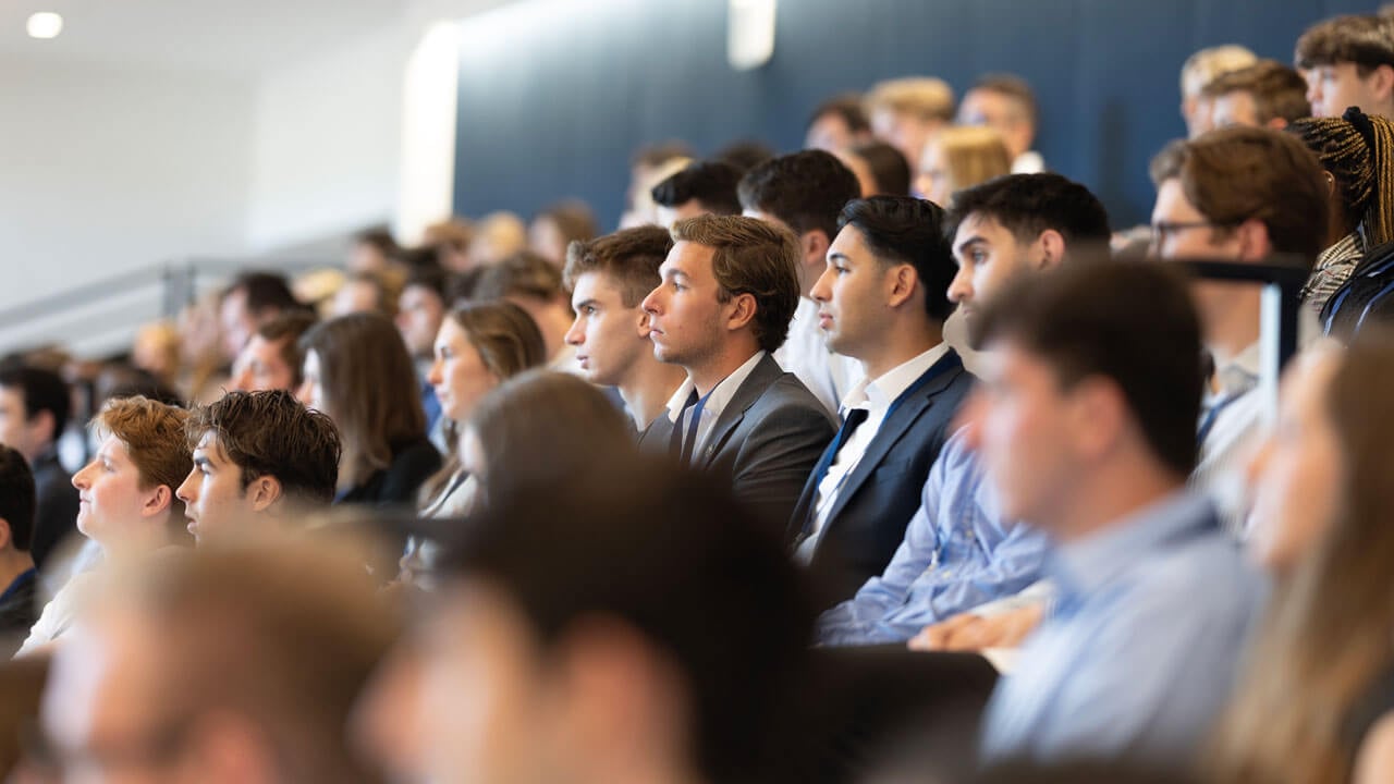 Audience of students dressed up look towards the stage