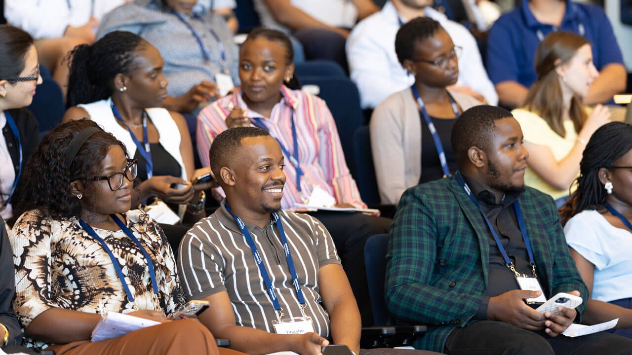 Audience looks up a smiles at speaker