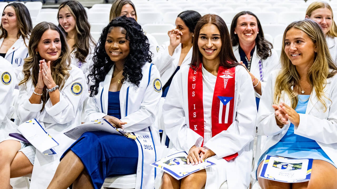 Nursing students sitting smiling at the 2025 pinning ceremony