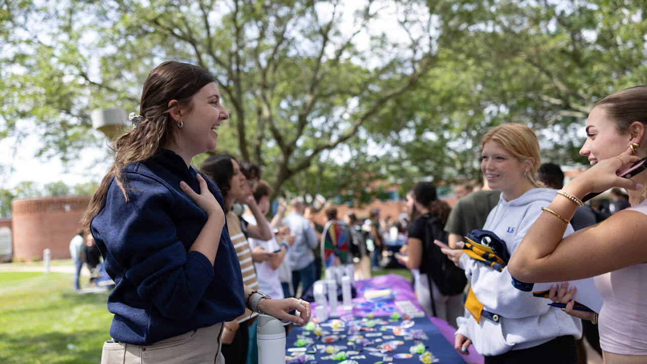 Students talk at a fair table