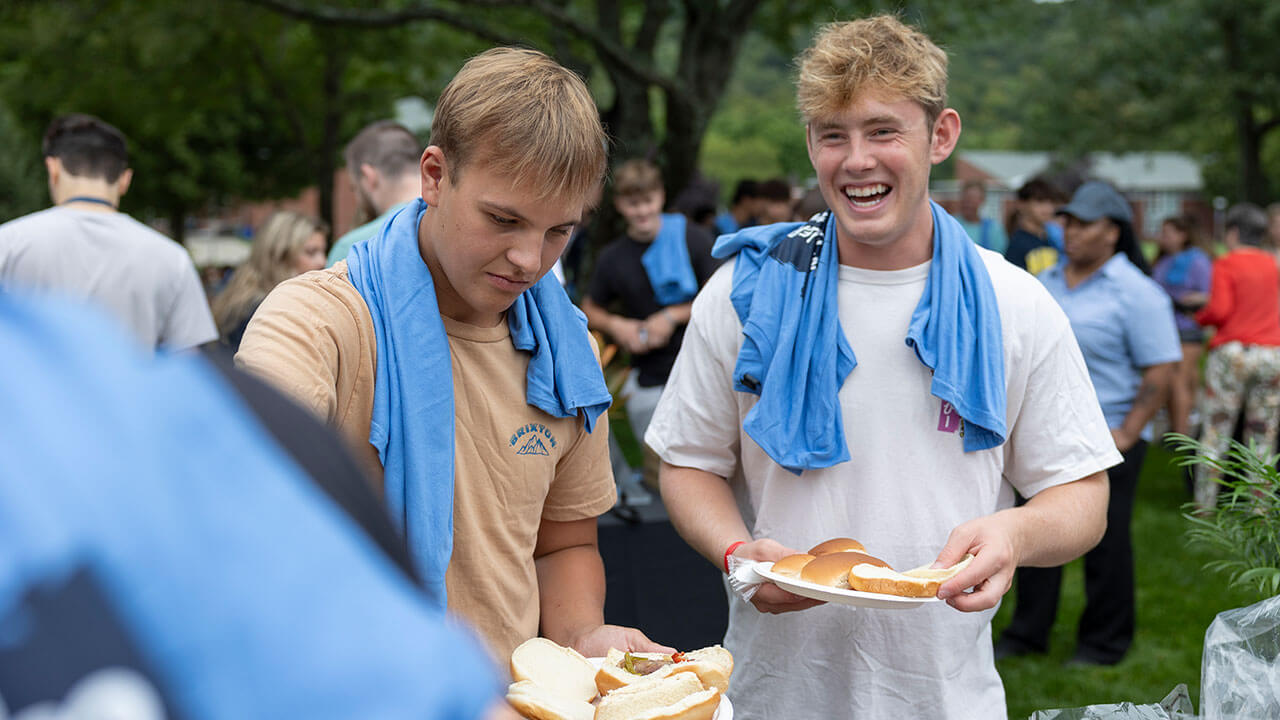 Boys smiling with burgers on their plates