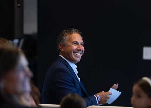 Chuck Saia smiling looking off into the distance