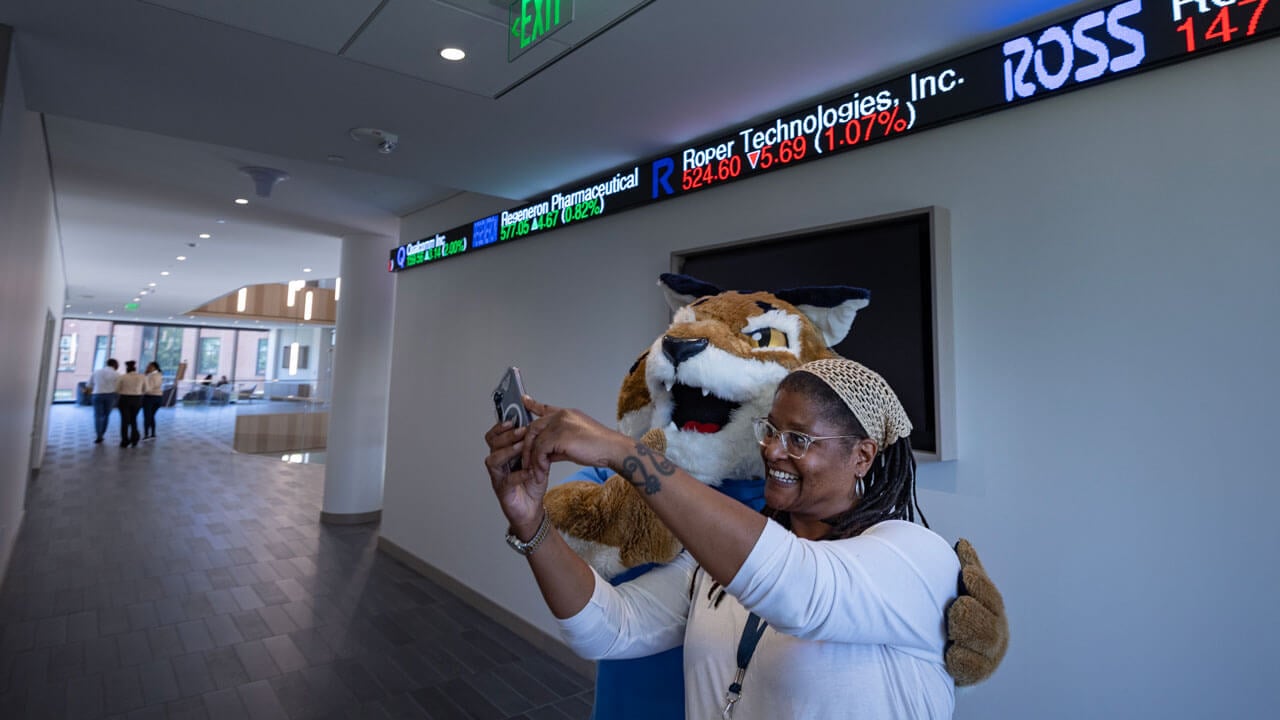 Person poses with boomer in the school of business