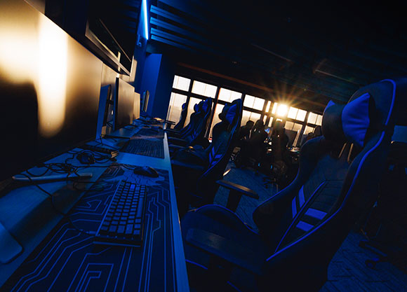 The sun rises through the window of the eSports lab room