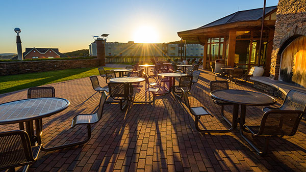 Sunrises over the patio of the Rocky Top Student Center on the York Hill Campus